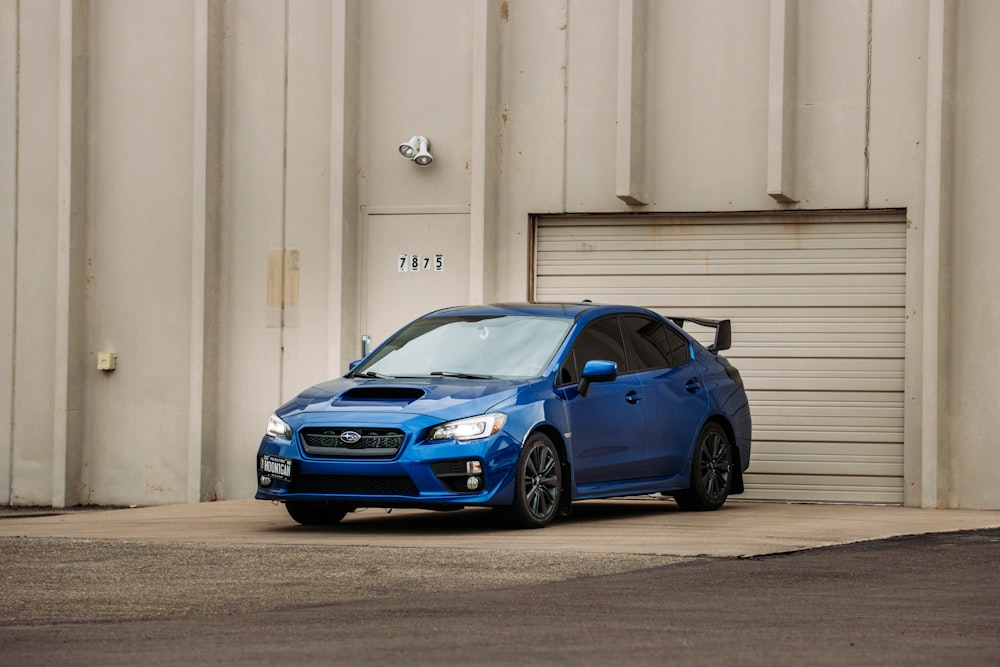 blue bmw m 3 coupe parked on gray concrete floor