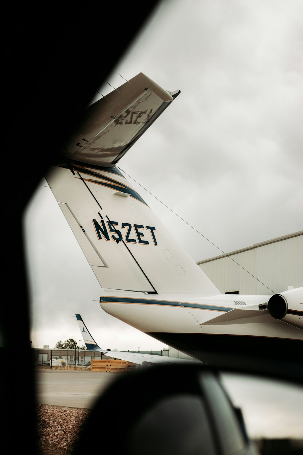 white and black airplane under white clouds during daytime