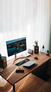 silver imac on brown wooden desk
