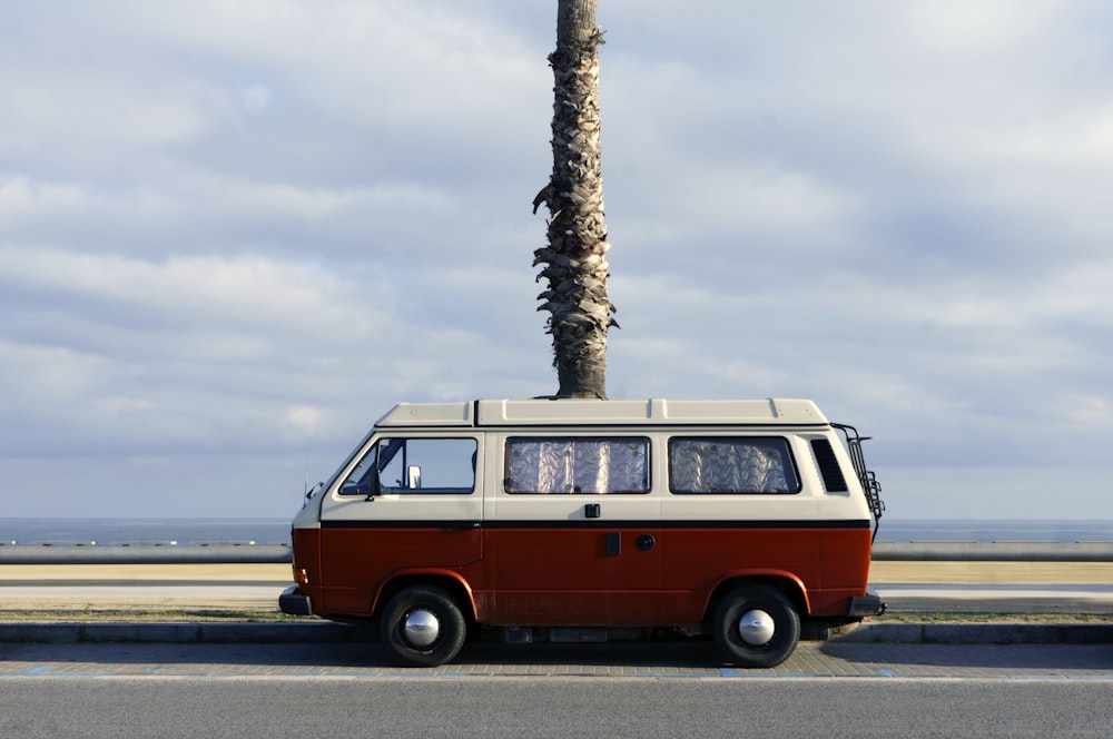 red and white volkswagen t-2 on road during daytime