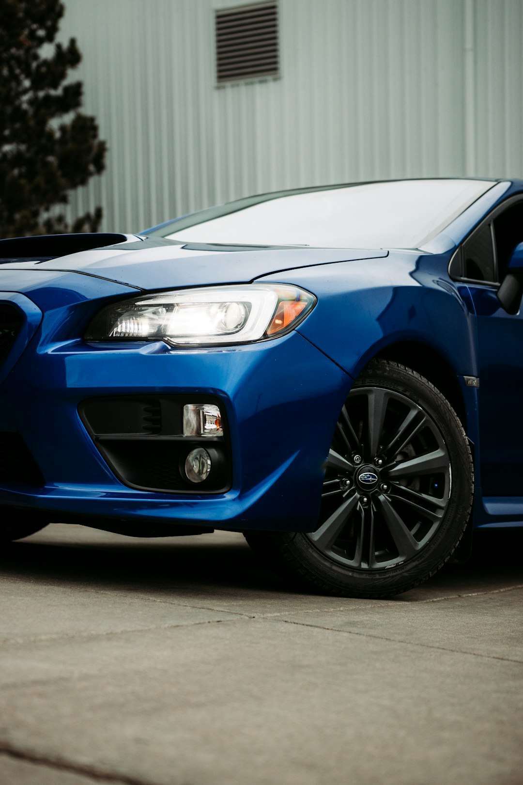 blue car on gray asphalt road during daytime