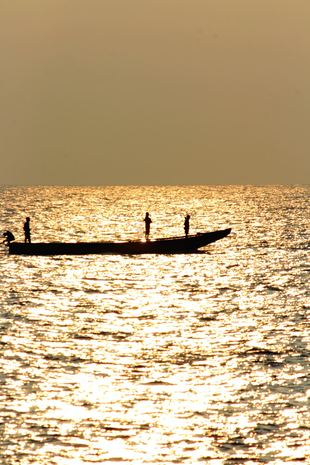 silhouette di 2 persone che cavalcano in barca durante il tramonto
