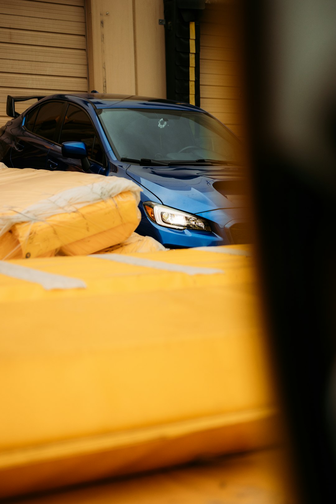 blue and black car in a garage