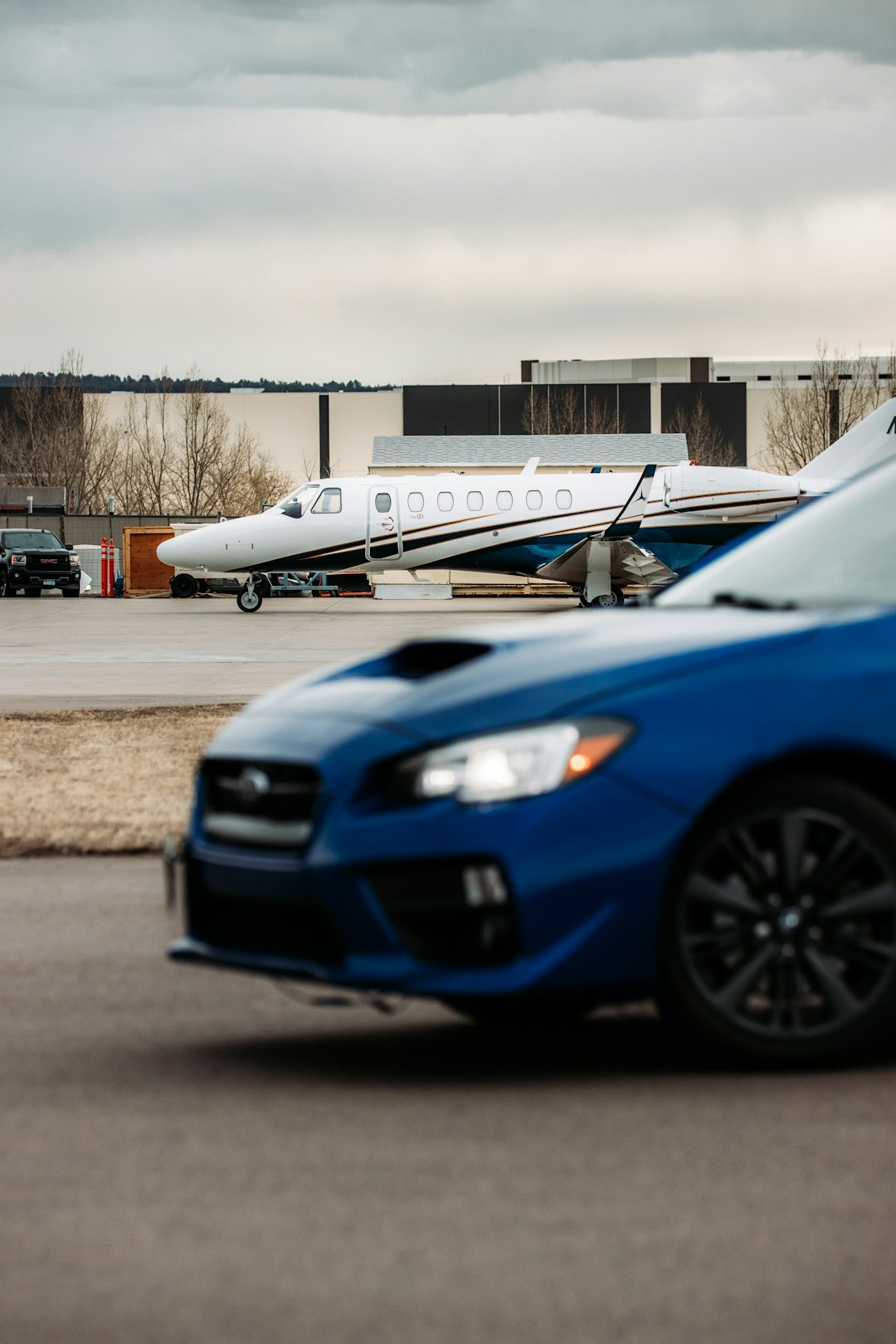 blue and white passenger plane on gray asphalt road during daytime