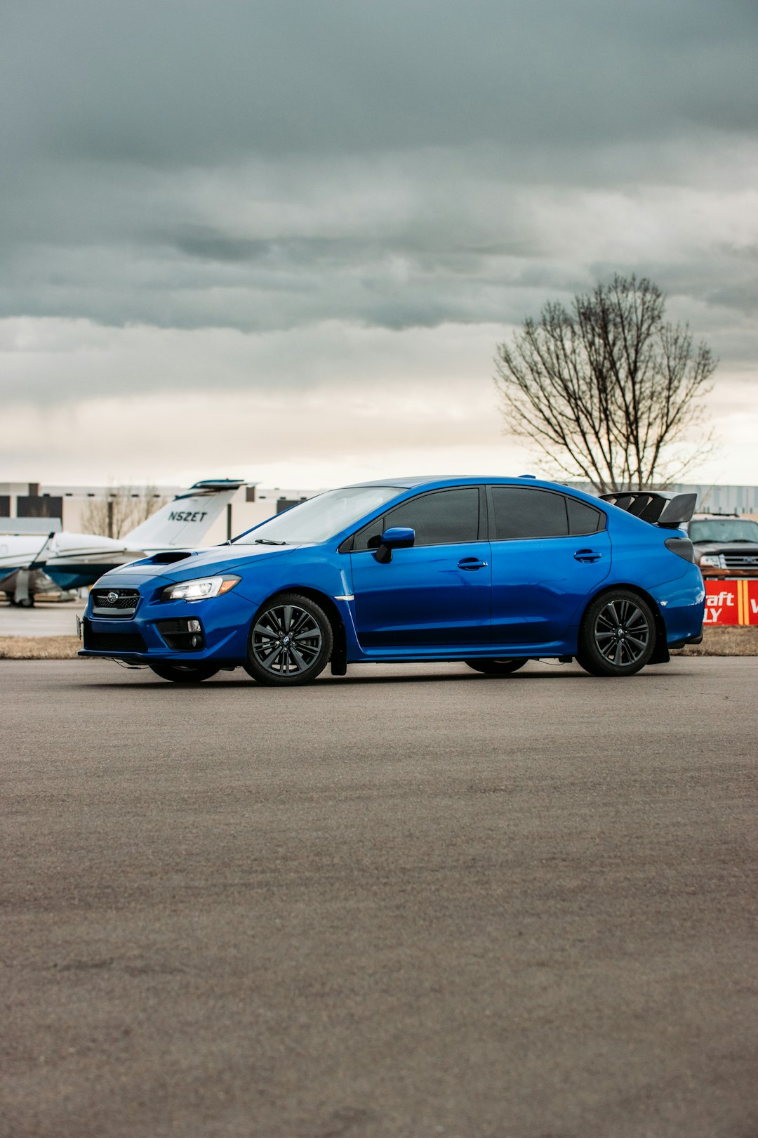 blue 5 door hatchback on road during daytime