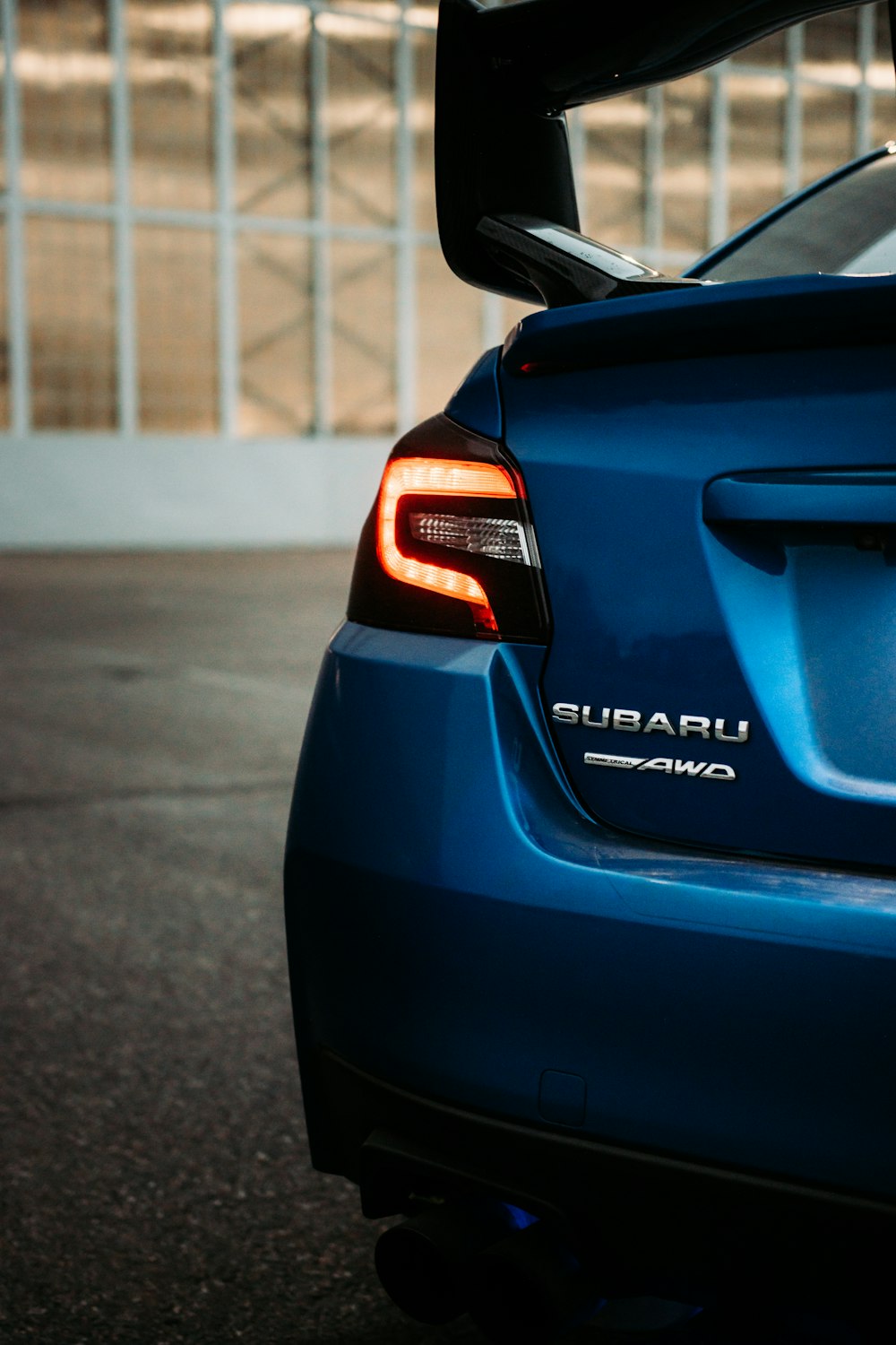 blue car on gray asphalt road during daytime