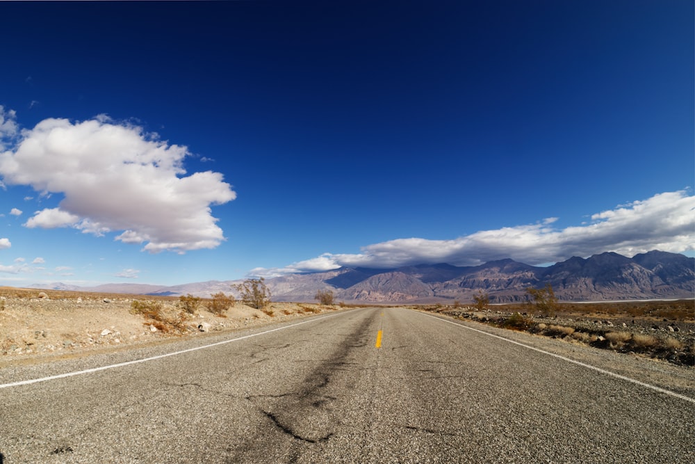 gray asphalt road under blue sky during daytime