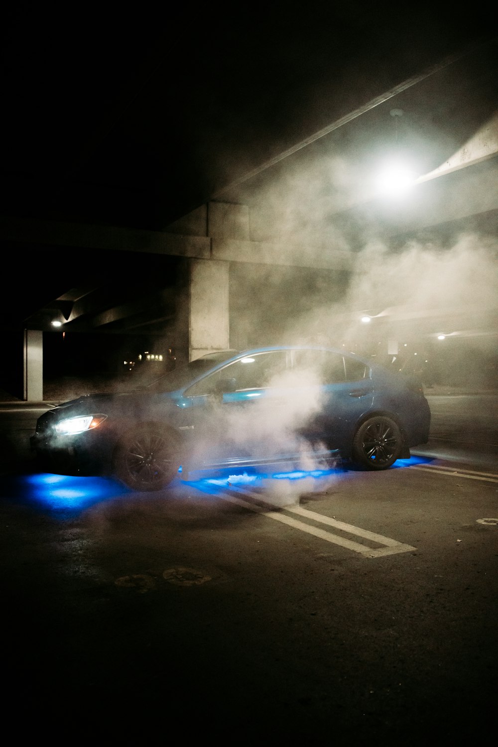 blue and white car on road during nighttime