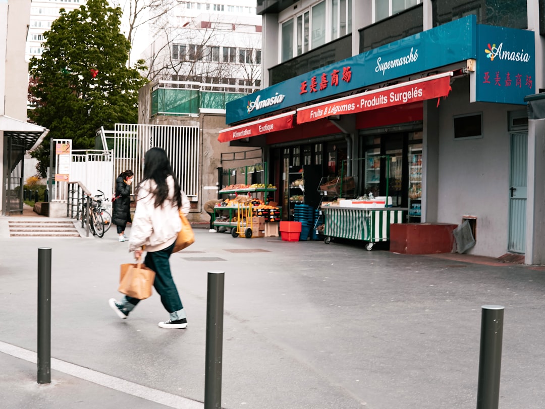 woman in white jacket sitting on gray concrete bench during daytime