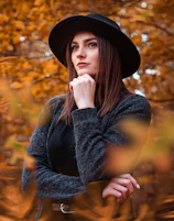 woman in black hat and black long sleeve shirt