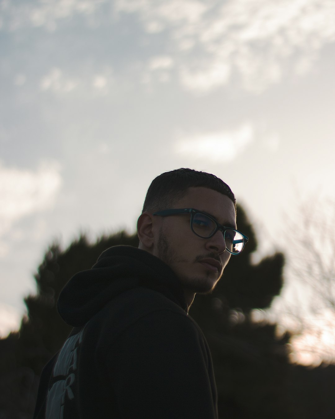 man in black hoodie wearing black sunglasses