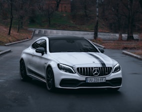 white mercedes benz coupe on road during daytime