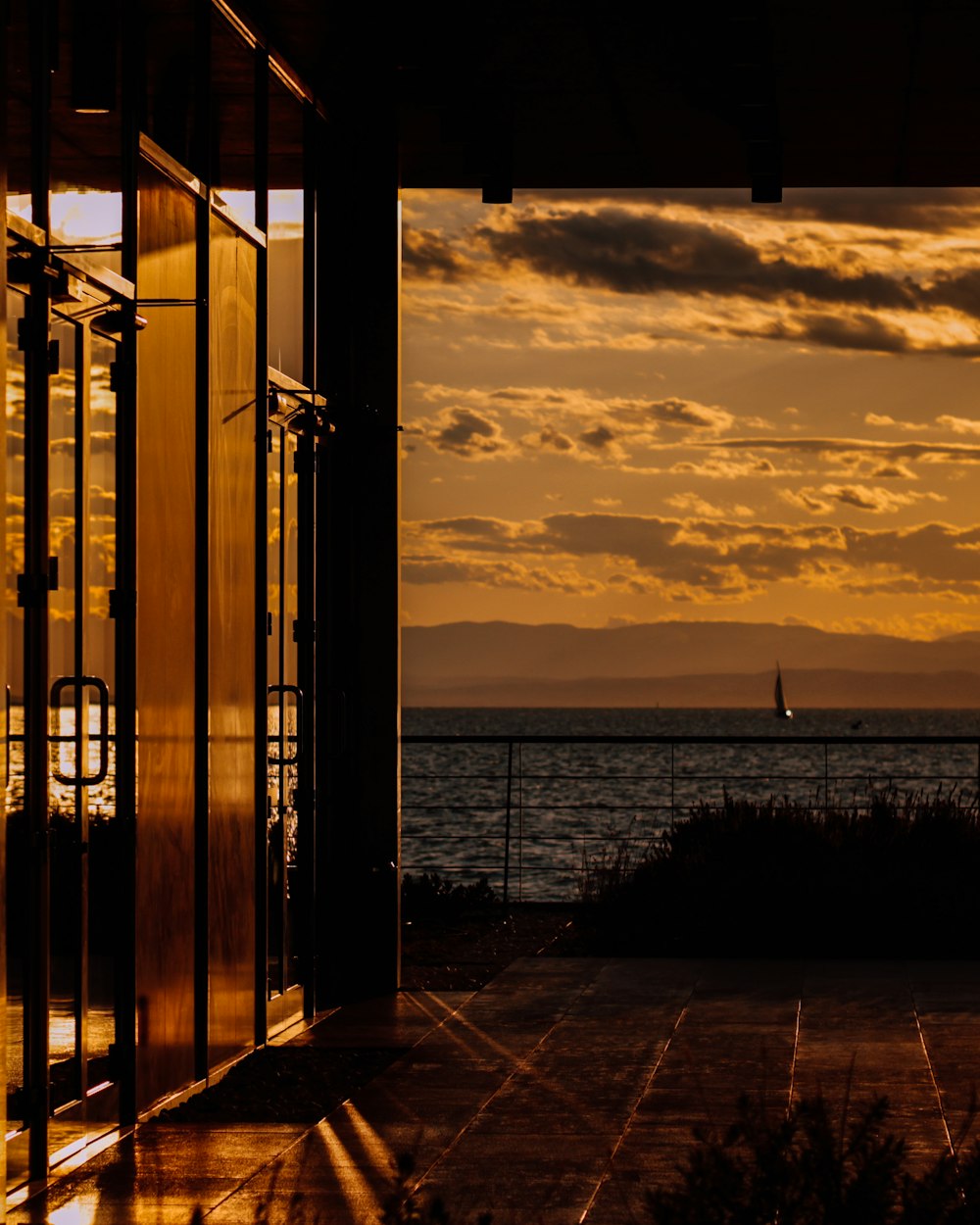 silhouette of person standing on the beach during sunset