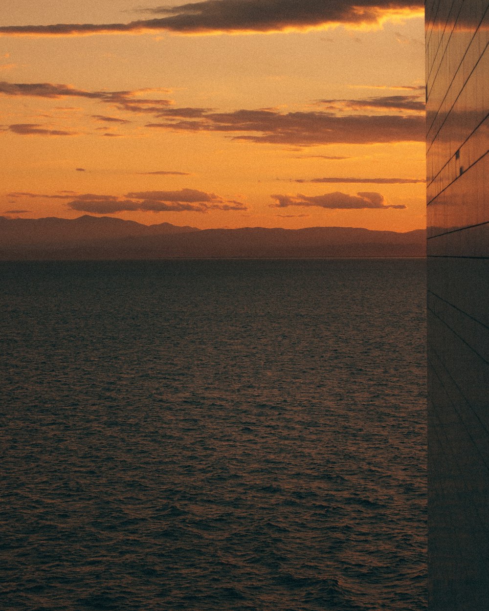 silhouette of sailboat on sea during sunset