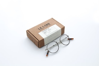 brown and white box with silver frame eyeglasses
