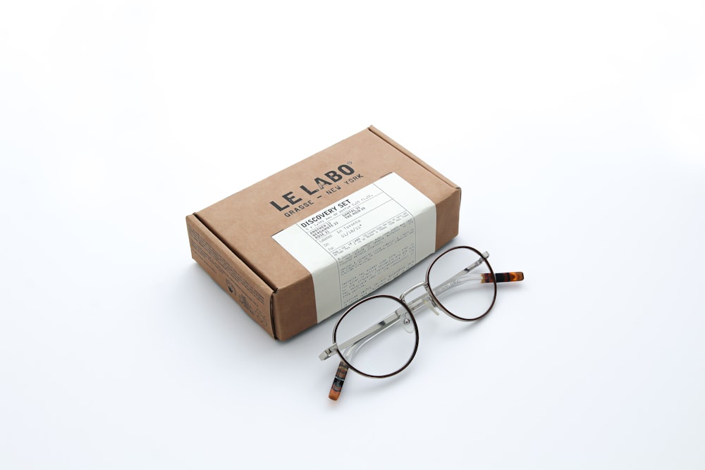 brown and white box with silver frame eyeglasses