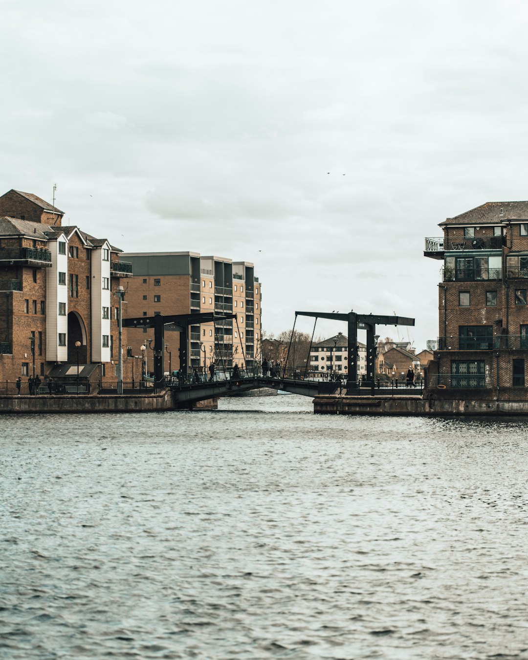 brown concrete building beside body of water during daytime