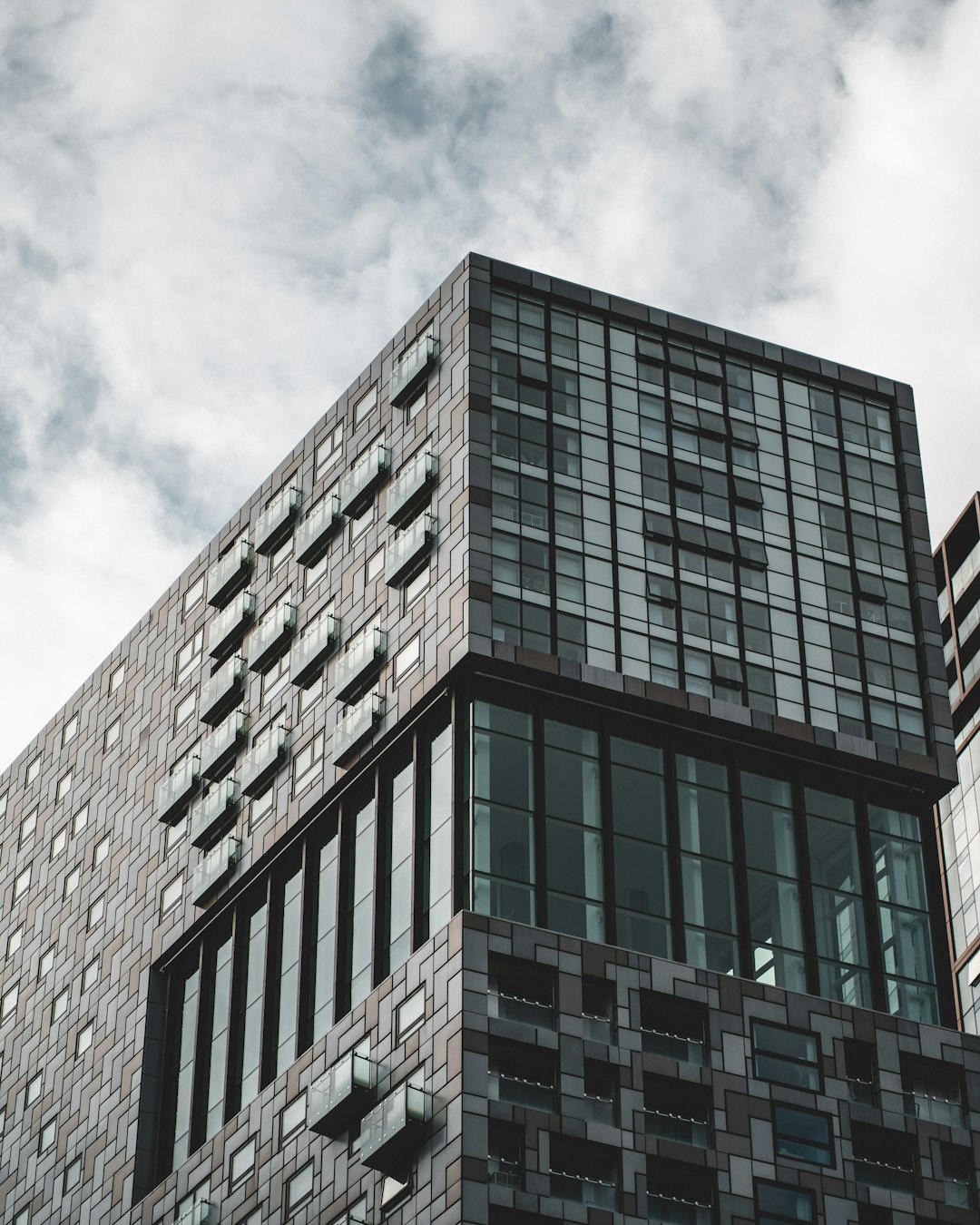 brown concrete building under cloudy sky during daytime