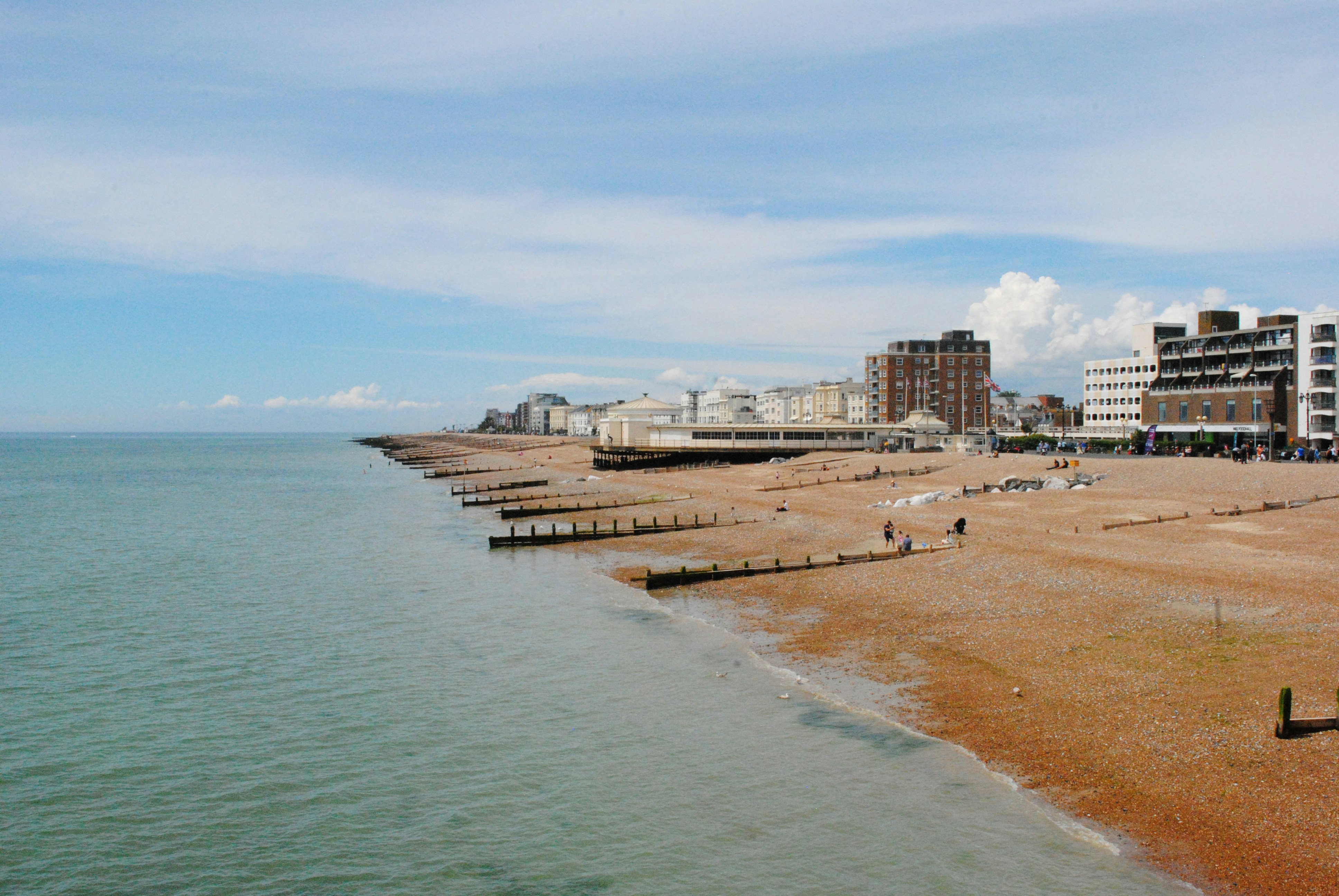 white concrete building near sea under blue sky during daytime
