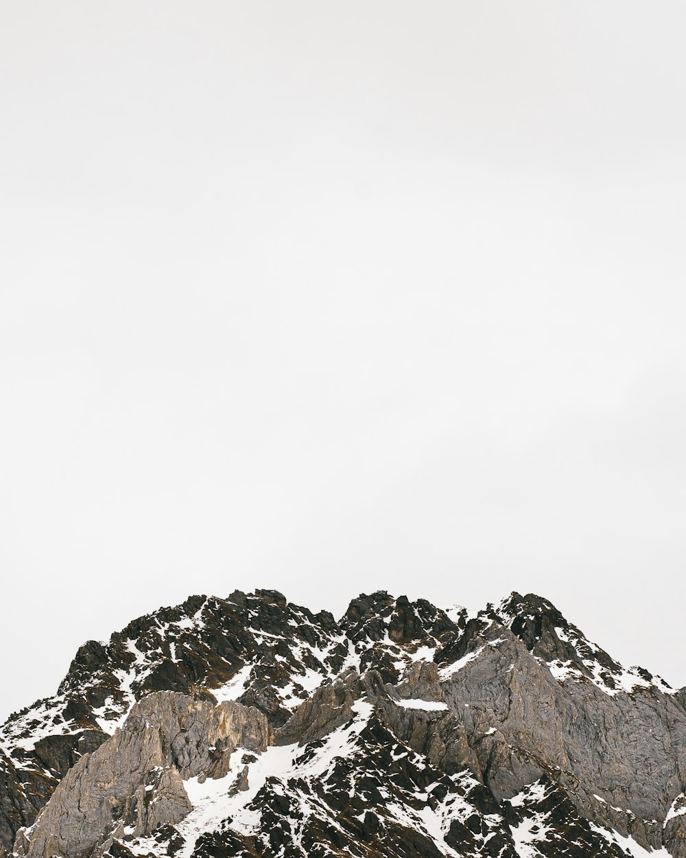 rocky mountain under white sky during daytime