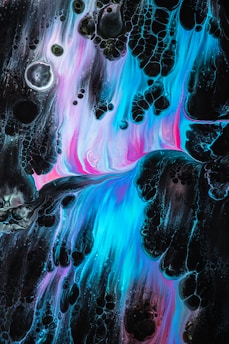 Abstract art featuring vibrant liquid flows with a mix of blue, pink, and black hues. The composition creates a dynamic movement with textures resembling bubbles and organic shapes.