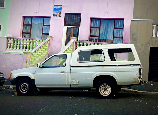 A weathered but still sturdy pickup truck waiting for donation pickup on a Staten Island street.