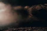 A mysterious landscape shrouded in fog and darkness.