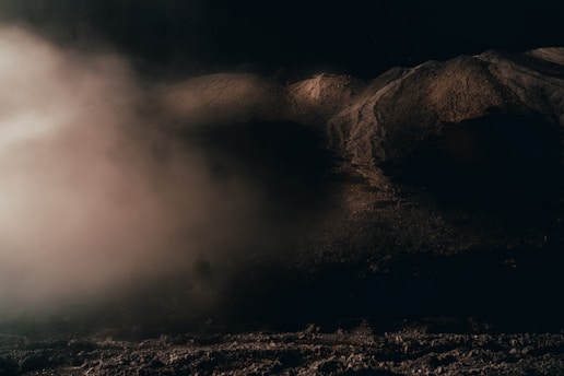 A dark fantasy landscape with shadowy mountains and a misty forest, evoking a sense of mystery and adventure.