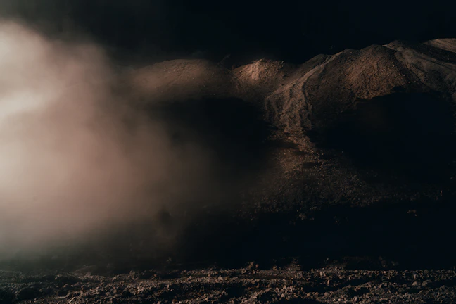 An eerie silhouette of an unidentified object casting shadows over a rural landscape.