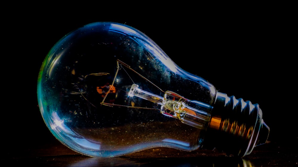 clear glass bottle with blue light