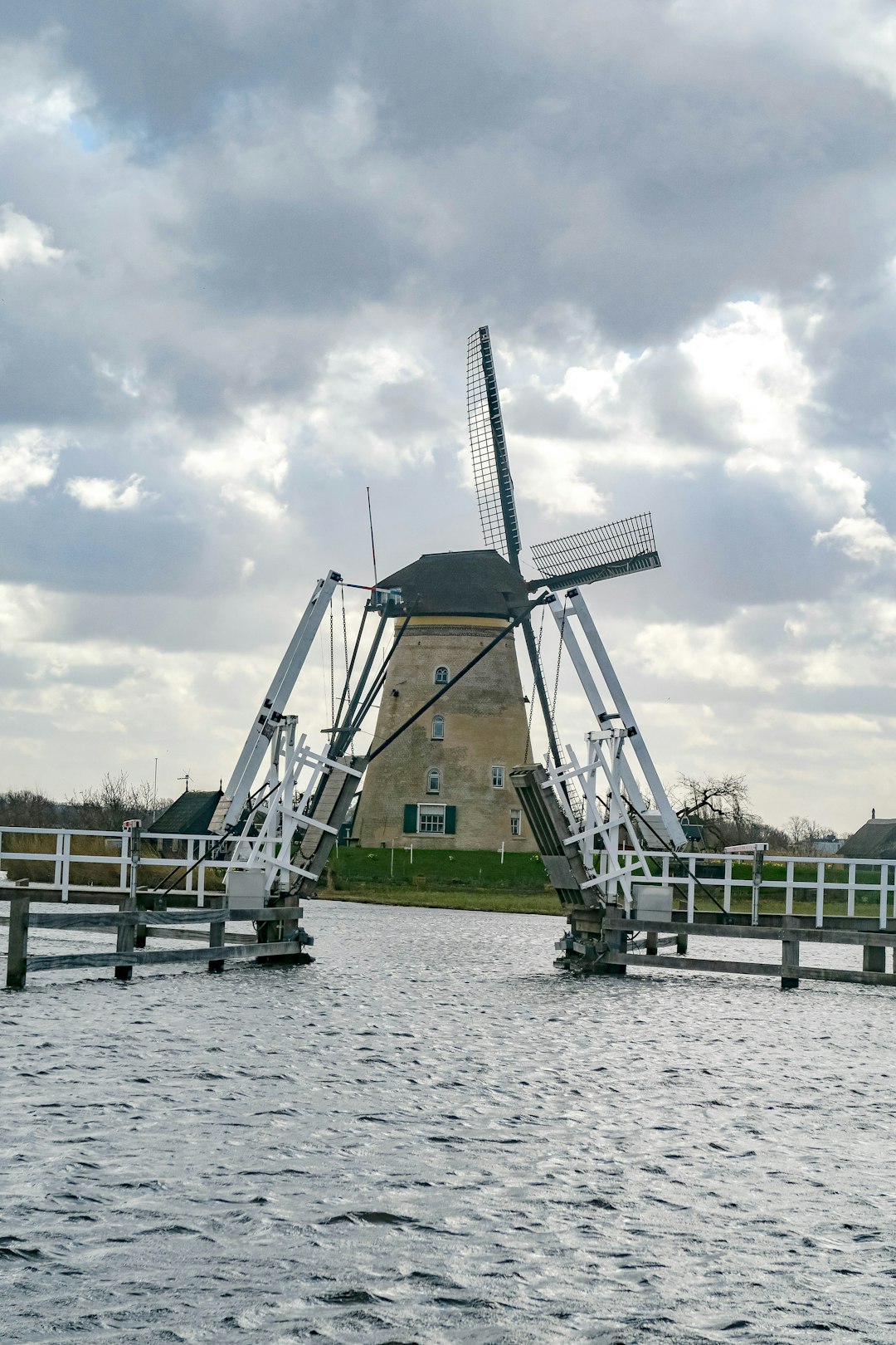 gray metal tower near body of water during daytime