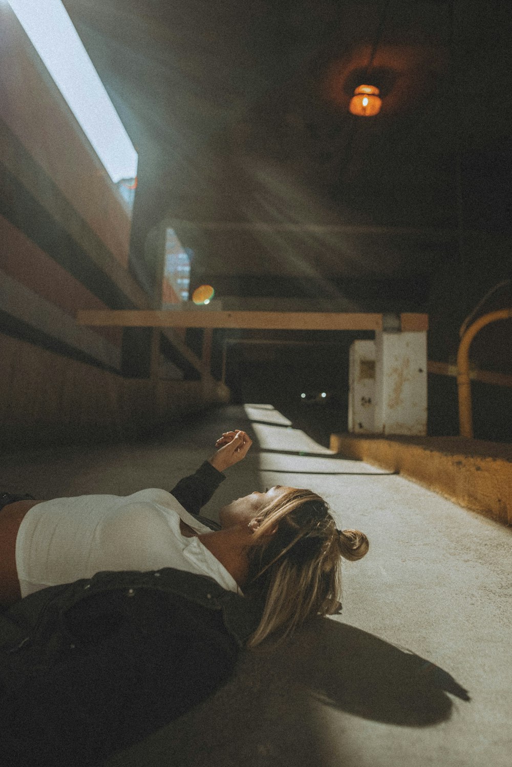 man in white shirt lying on floor