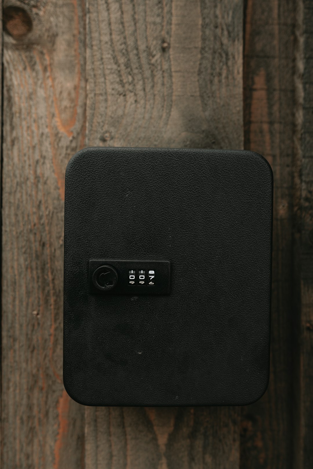 black speaker on brown wooden table