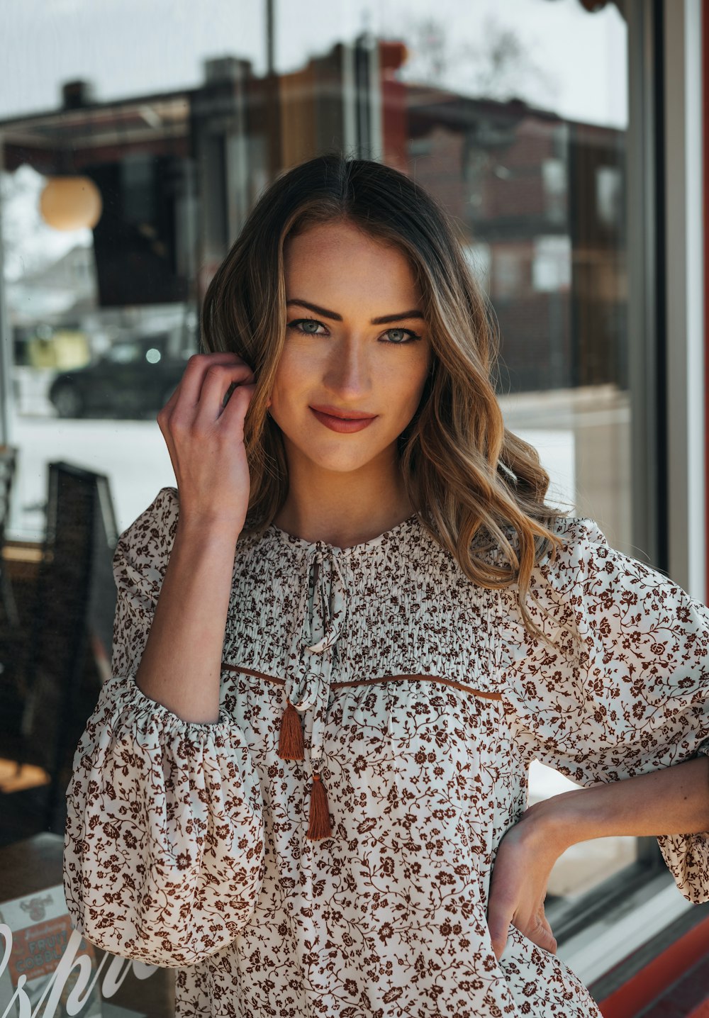 woman in white red and black floral shirt