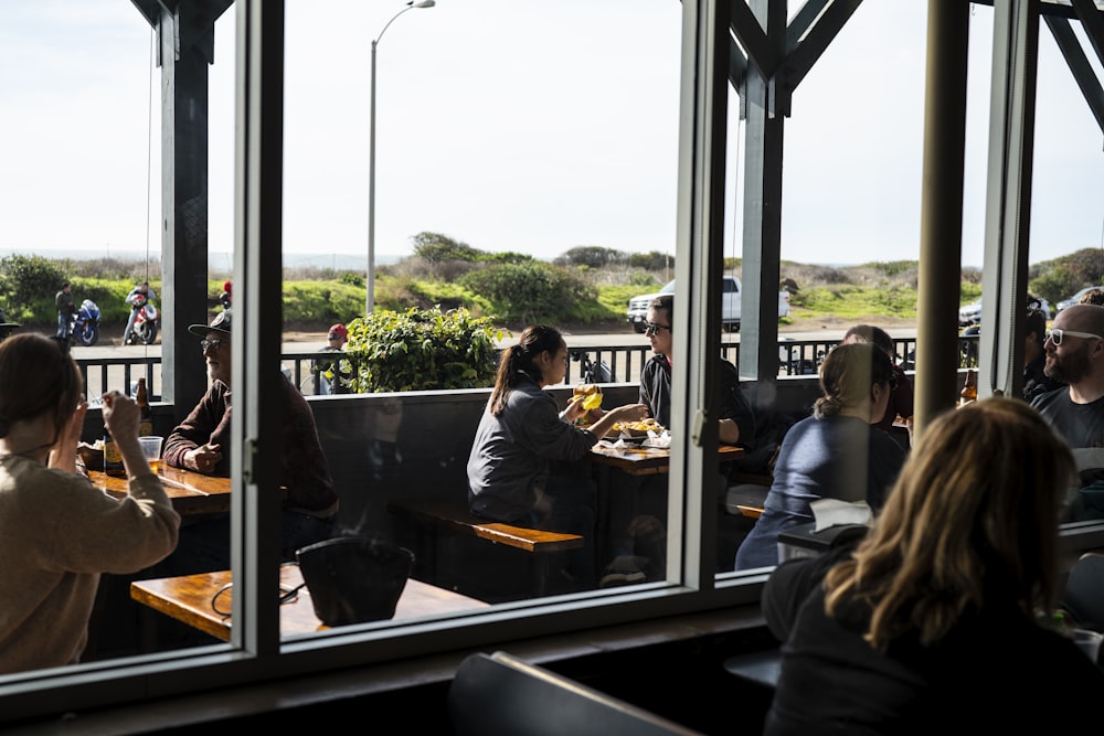 people sitting on chair inside restaurant during daytime