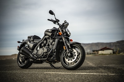 black and silver cruiser motorcycle on gray asphalt road during daytime