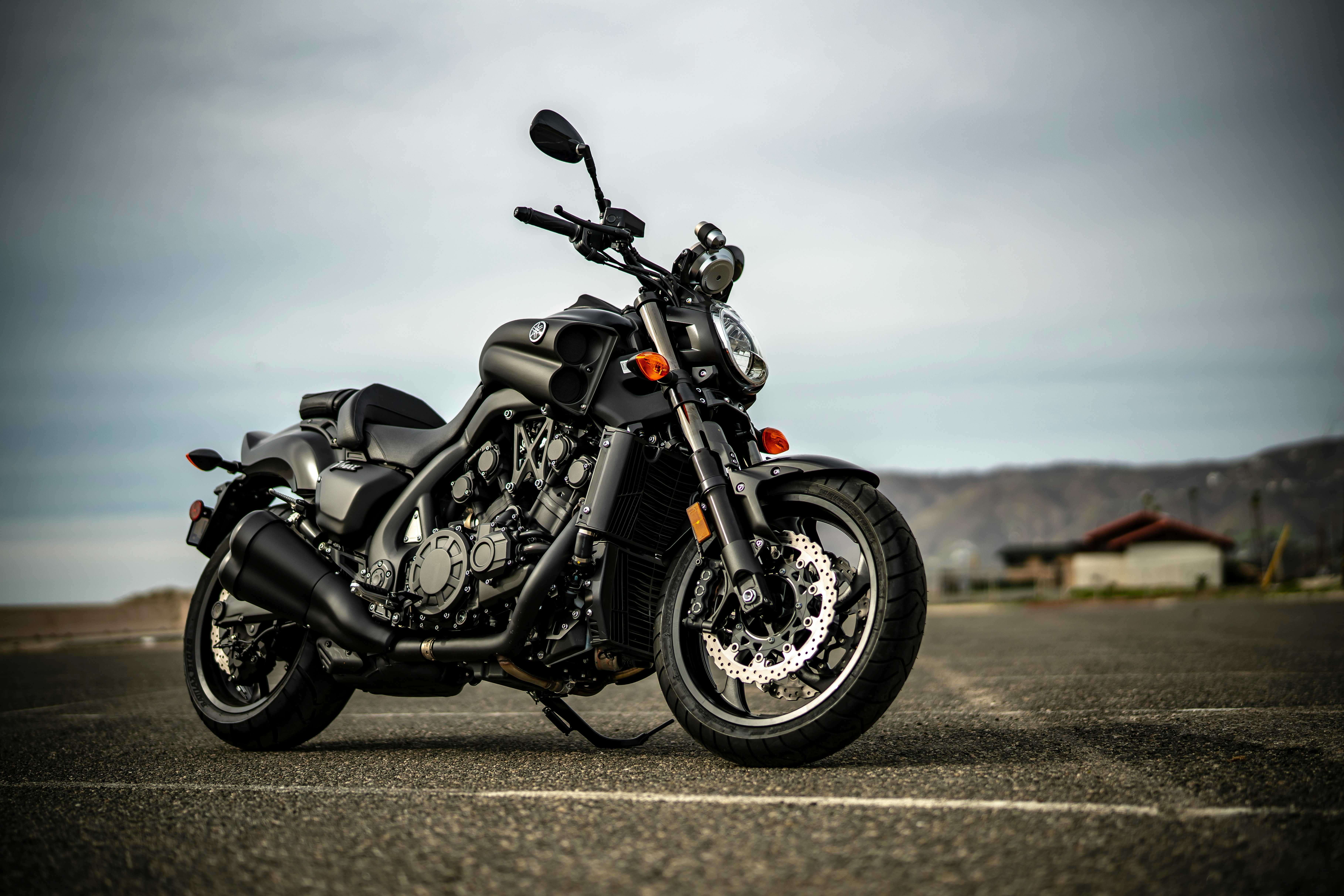 black and silver cruiser motorcycle on gray asphalt road during daytime