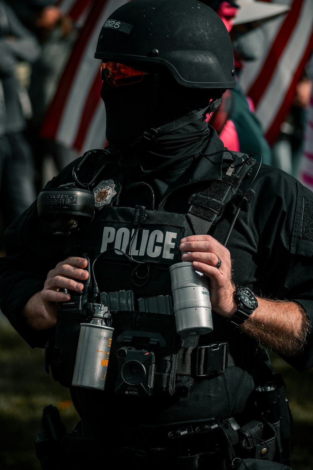 man in black leather jacket holding black dslr camera