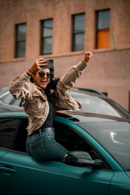 A happy driver receiving confirmation of their new auto insurance on a smartphone.