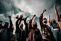 group of people raising their hands