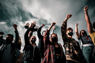 group of people raising their hands