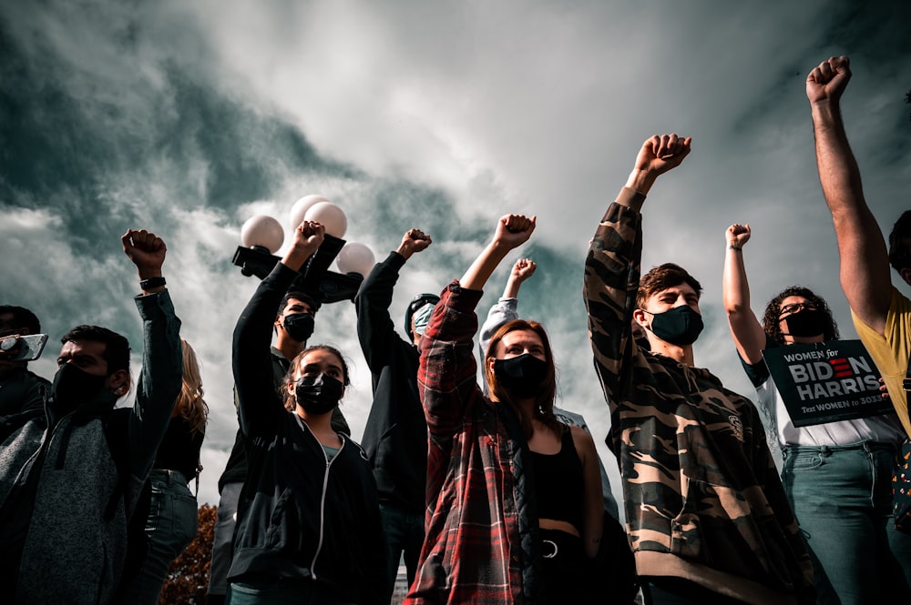 group of people raising their hands