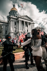 people walking on green grass field near white concrete building during daytime