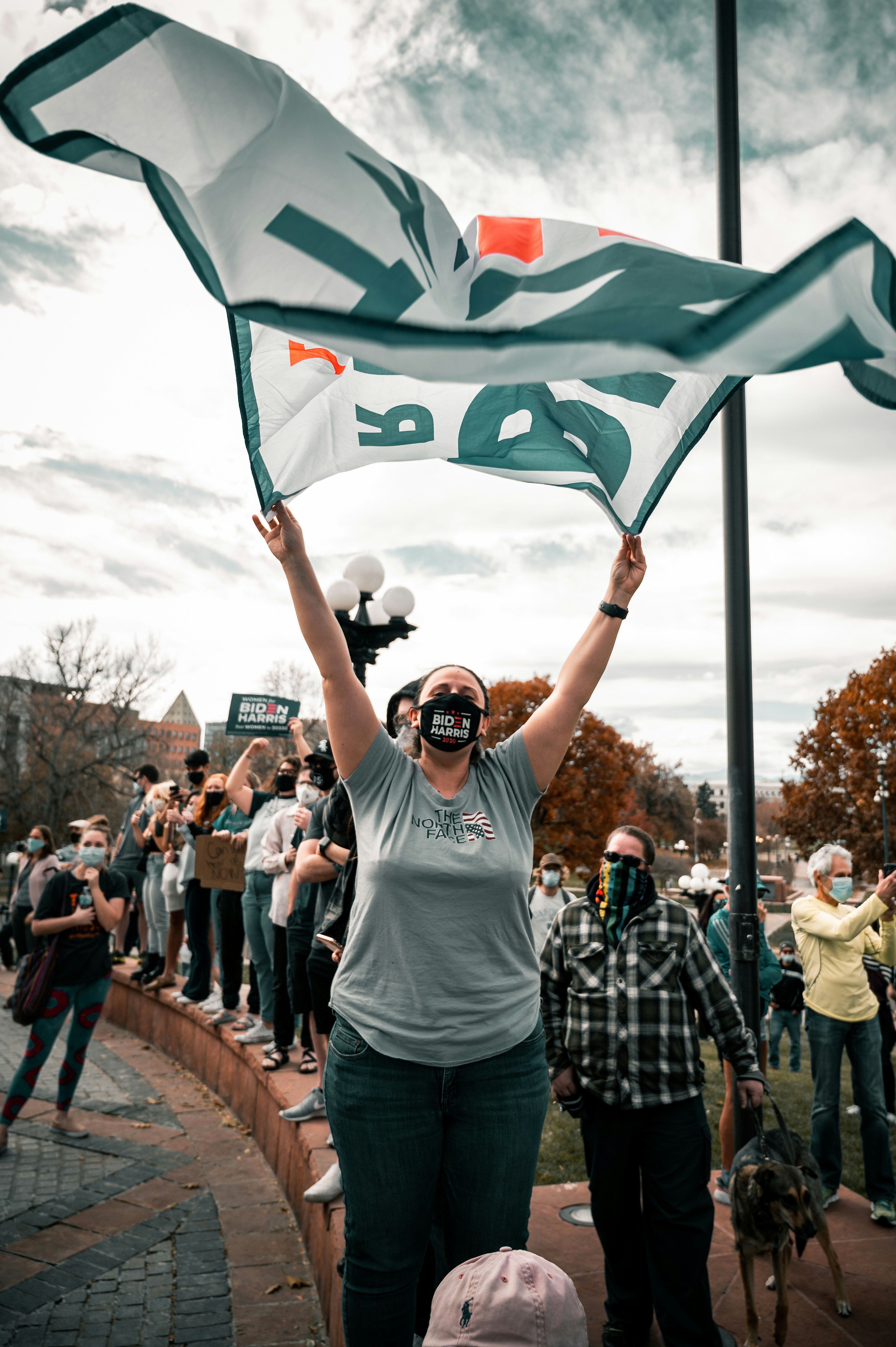 man in white crew neck t-shirt holding green flag