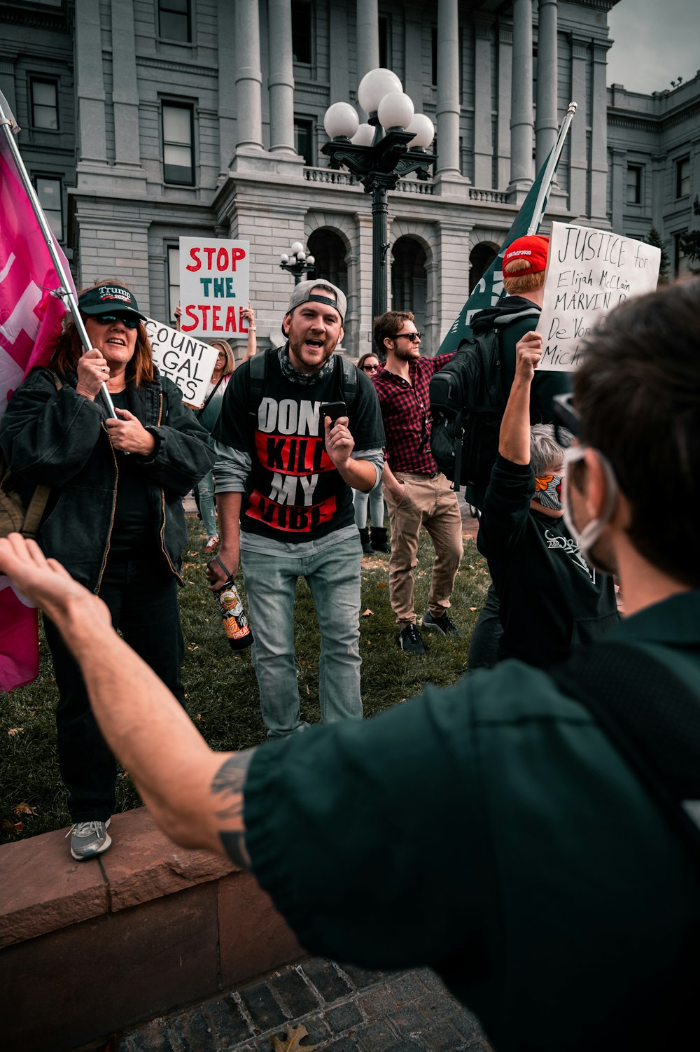 people standing and holding flags during daytime