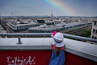 Poppy and Penny happily coloring at the Eiffel Tower on a sunny day.