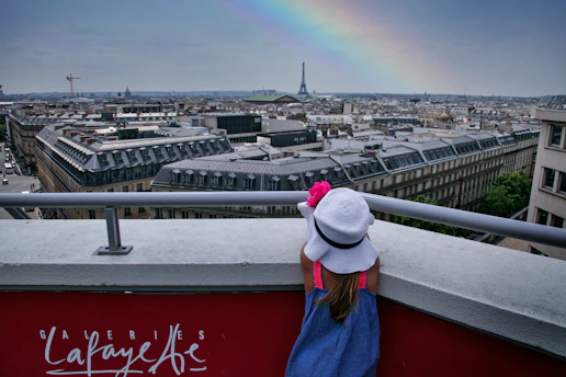 Poppy and Penny happily coloring at the Eiffel Tower on a sunny day.