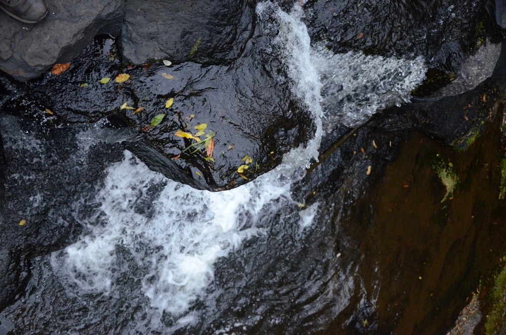 water falls on brown rocky mountain