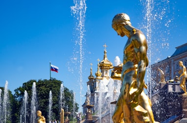 gold statue of man with flags on top