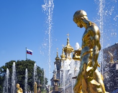 gold statue of man with flags on top